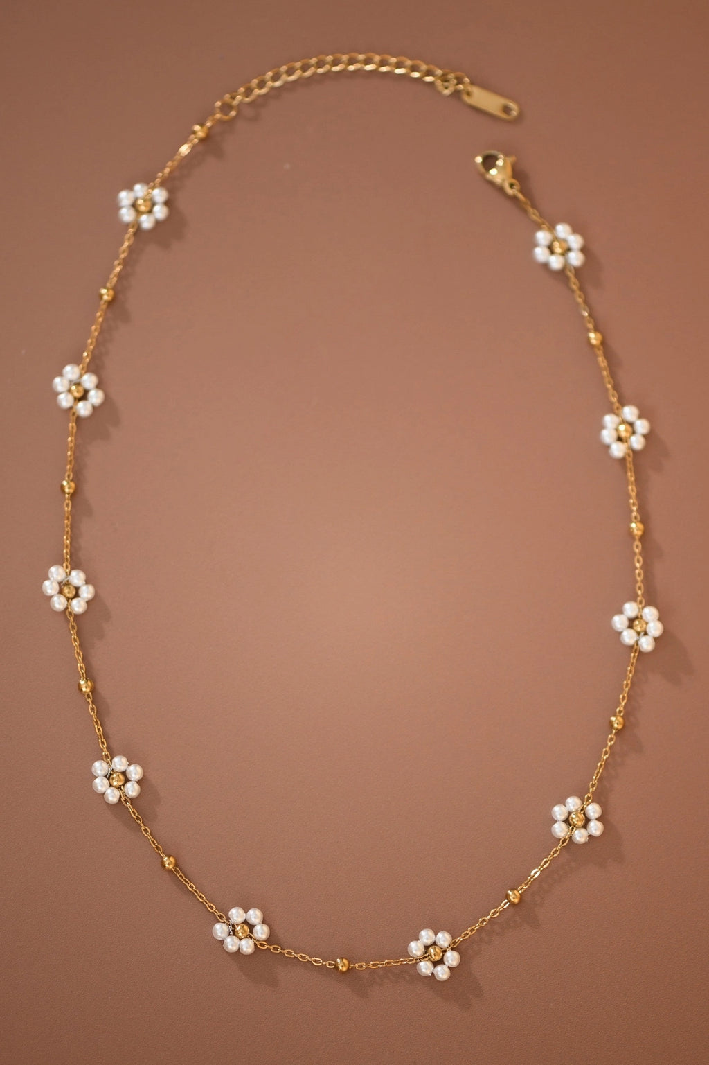 Close-up of the intricate flower beads on the Kogi Jewelry 18K gold plated necklace.