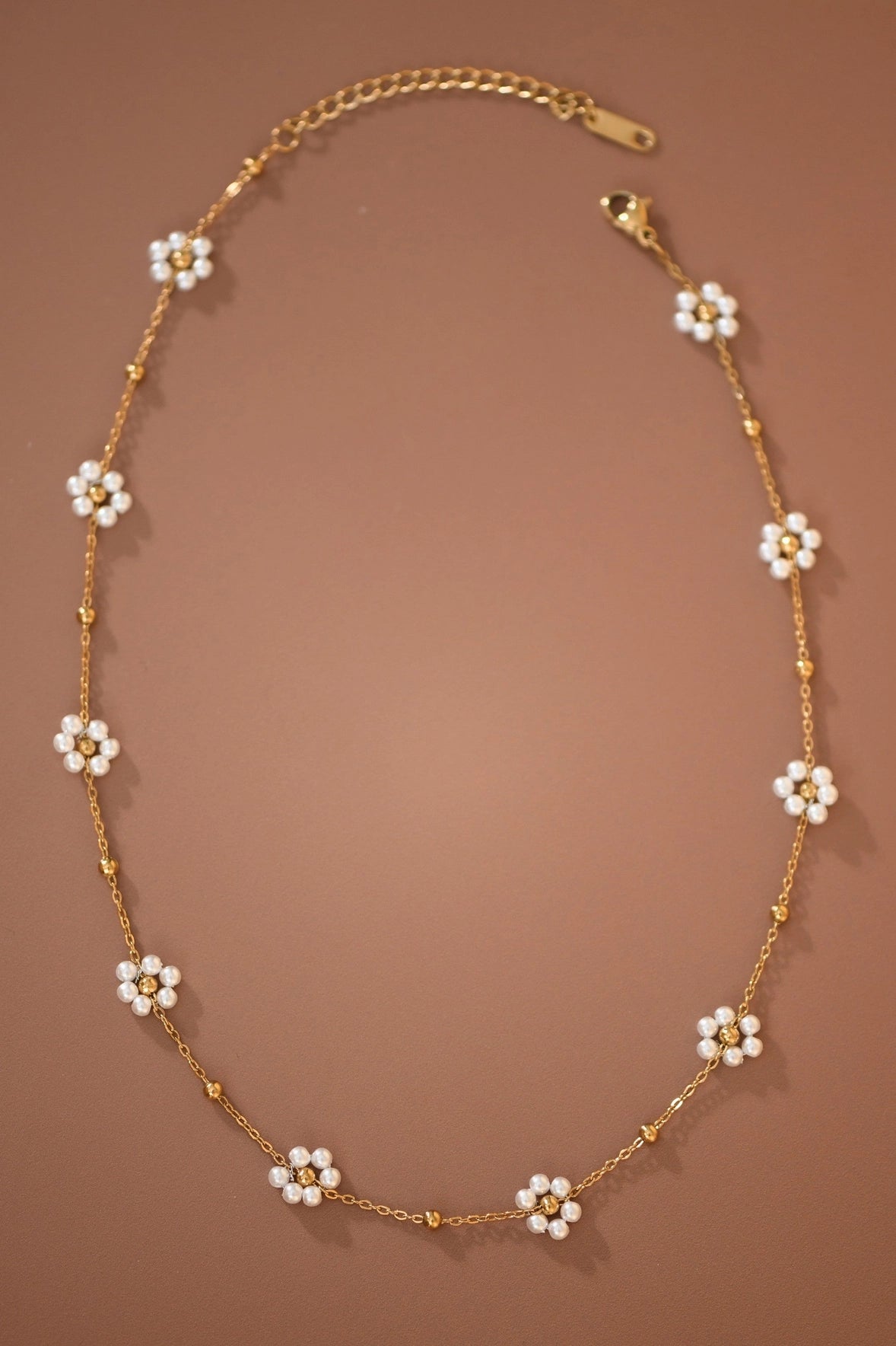 Close-up of the intricate flower beads on the Kogi Jewelry 18K gold plated necklace.