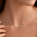 18K gold plated stainless steel necklace featuring a delicate bow charm by Kogi Jewelry.