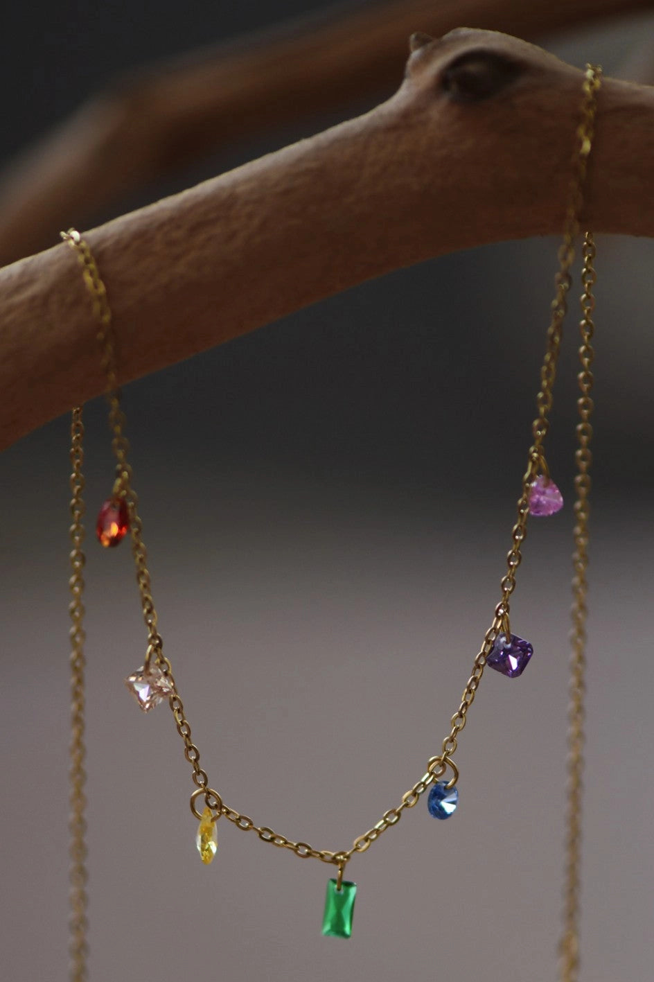 Detailed close-up of a 18K gold plated stainless steel dainty necklace featuring colorful cubic zirconia crystals by Kogi Jewelry.