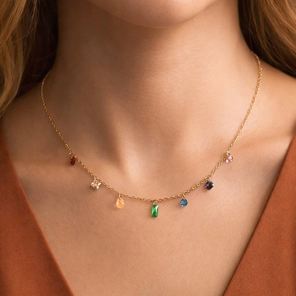 Dainty gold necklace with colorful crystals worn on neck, highlighting its vibrant and elegant sparkle.