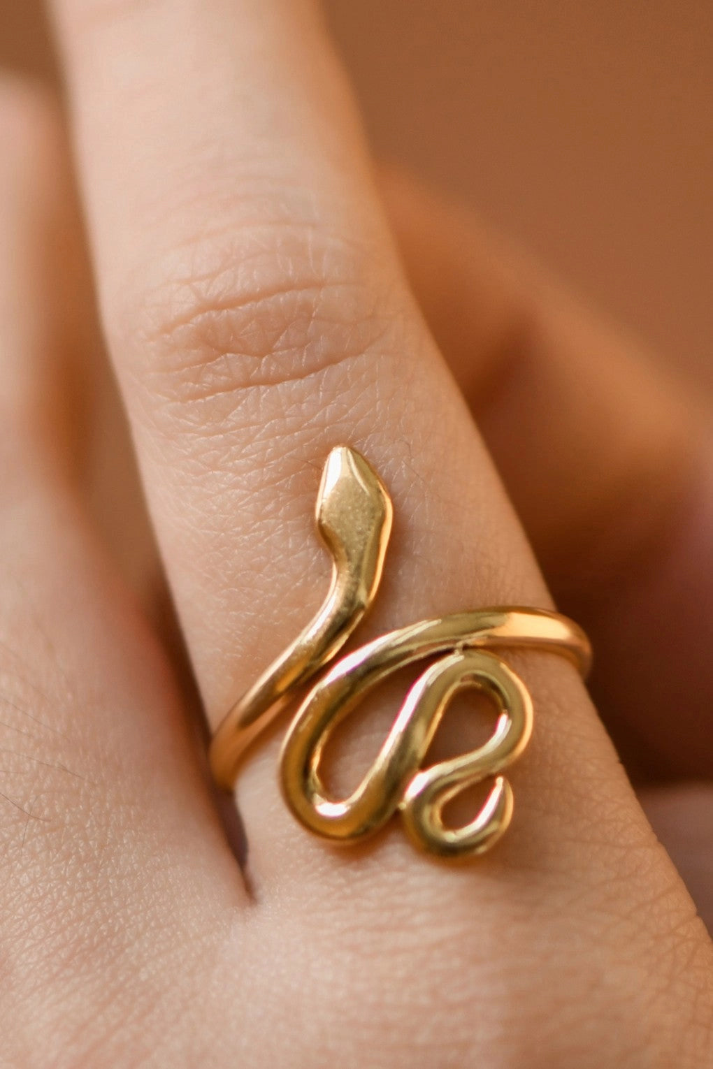 18K gold plated stainless steel snake wrap adjustable ring worn on finger by Kogi Jewelry.