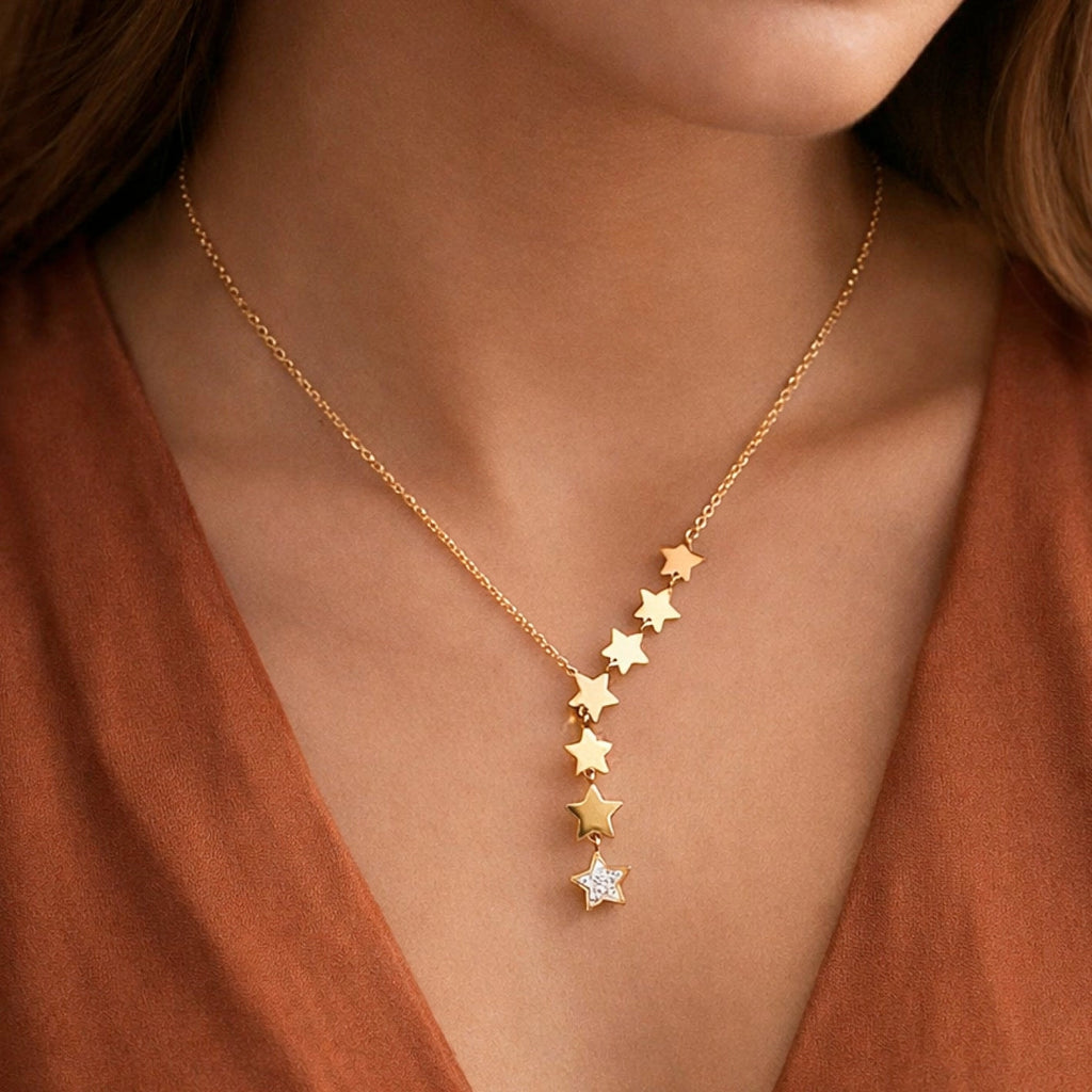 Celestial star lariat necklace in gold worn on neck, showcasing the elegant drop design.