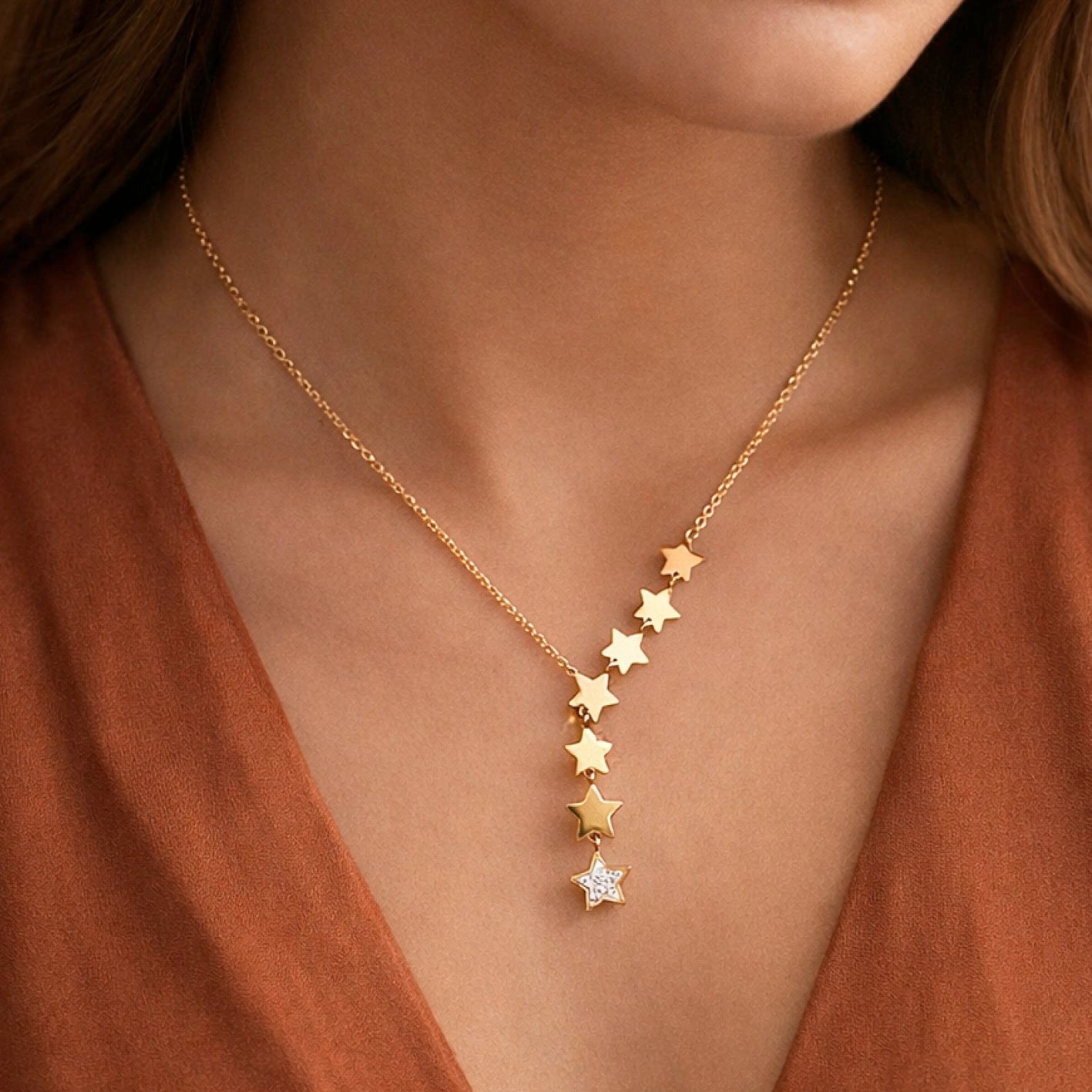 Celestial star lariat necklace in gold worn on neck, showcasing the elegant drop design.