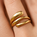 Sculptural triple band gold ring worn on hand with polished 18K gold finish