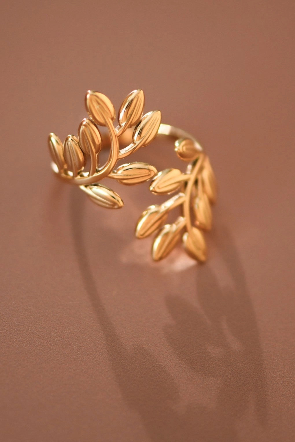 Close-up of the intricate leafy branch patterns on the Kogi Jewelry 18K gold plated adjustable ring.