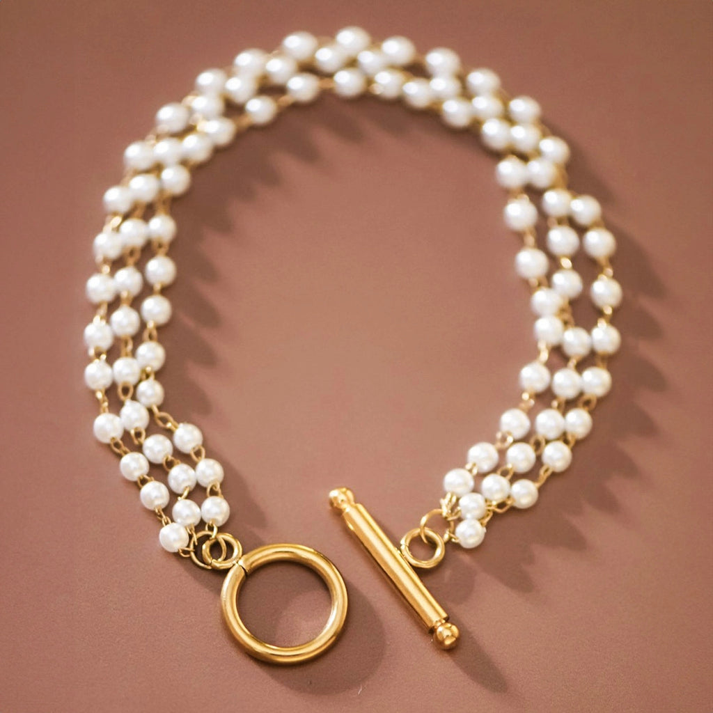 18k gold plated multi-strand pearl bracelet on brown background by Kogi Jewelry
