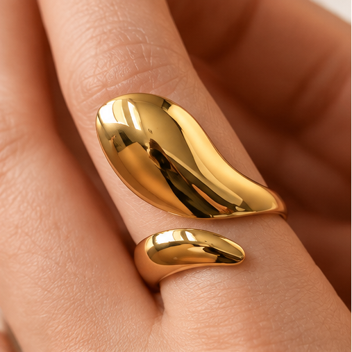 18K PVD gold sculptural ring worn on finger showing asymmetrical curved design