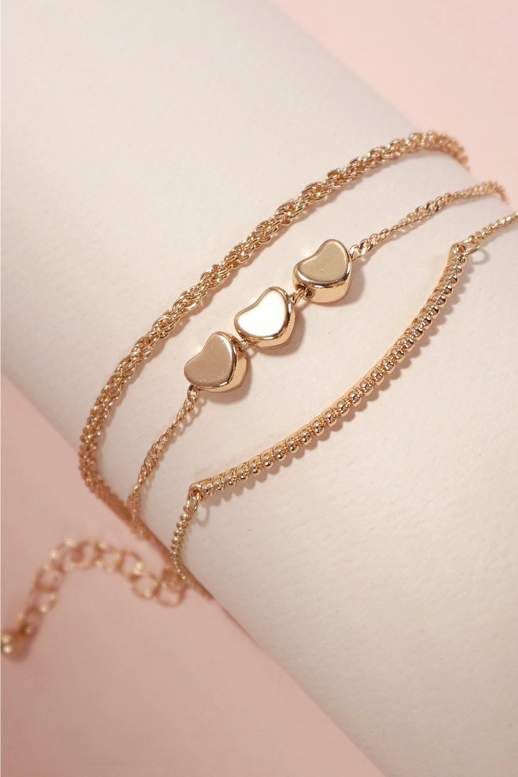 Detail of the lobster claw clasp and 2-inch extender on the gold layered charm bracelet.