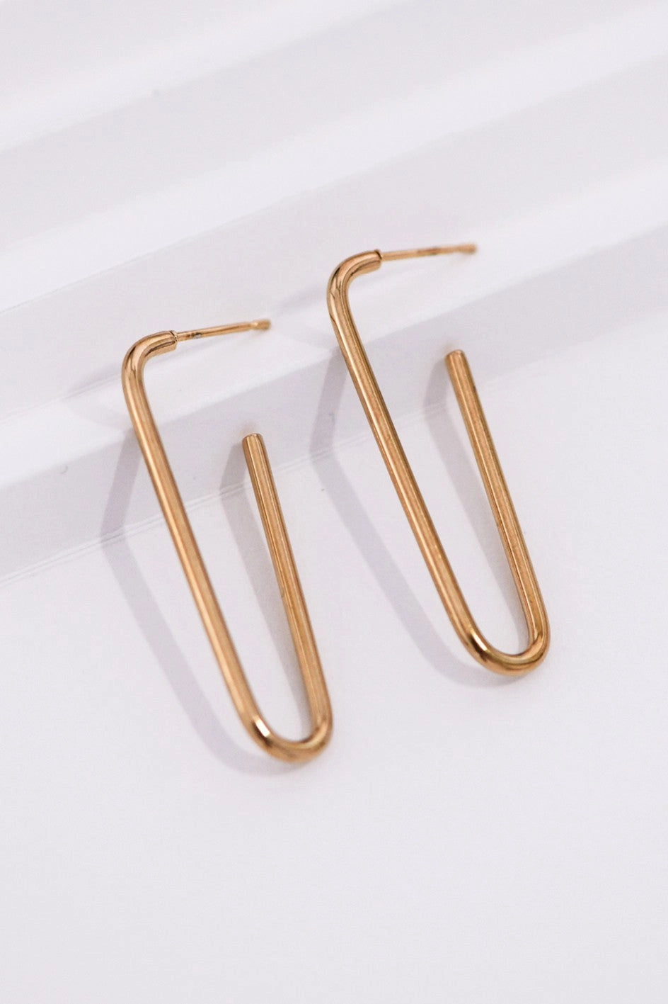 Close-up detail of the secure clasp and polished surface of the Kogi Jewelry gold hoops.