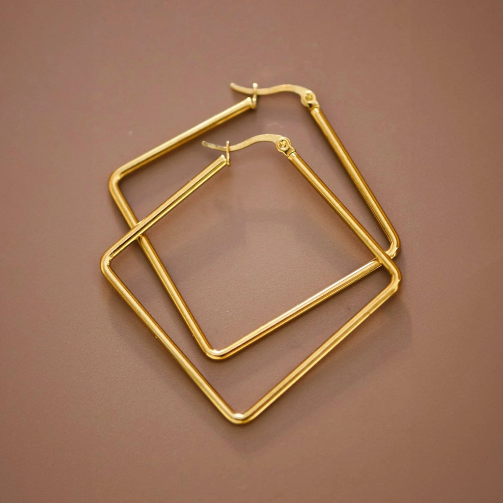 Detailed close-up of the polished surface and clean angles of the Kogi Jewelry oversized square hoops.