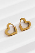 18K gold plated stainless steel mini heart-shaped huggie earrings held between fingers by Kogi Jewelry.