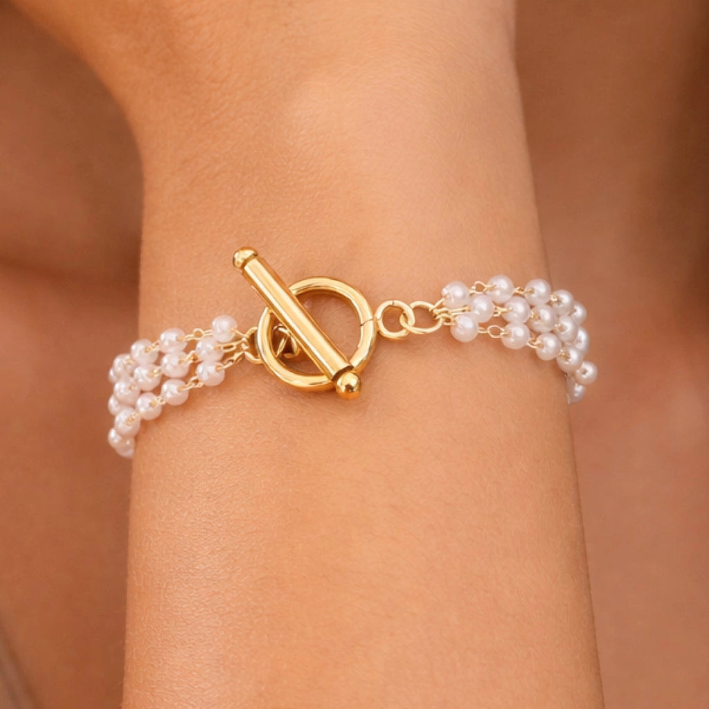 Elegant multi-layer pearl and 18k gold plated bracelet showcasing the rich gold tone