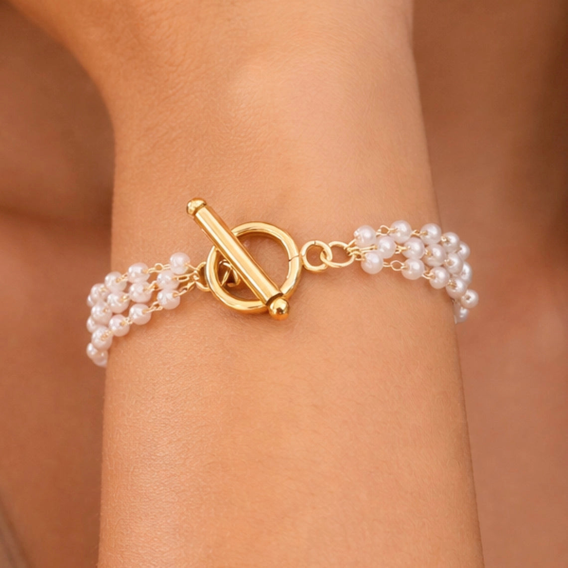 Elegant multi-layer pearl and 18k gold plated bracelet showcasing the rich gold tone