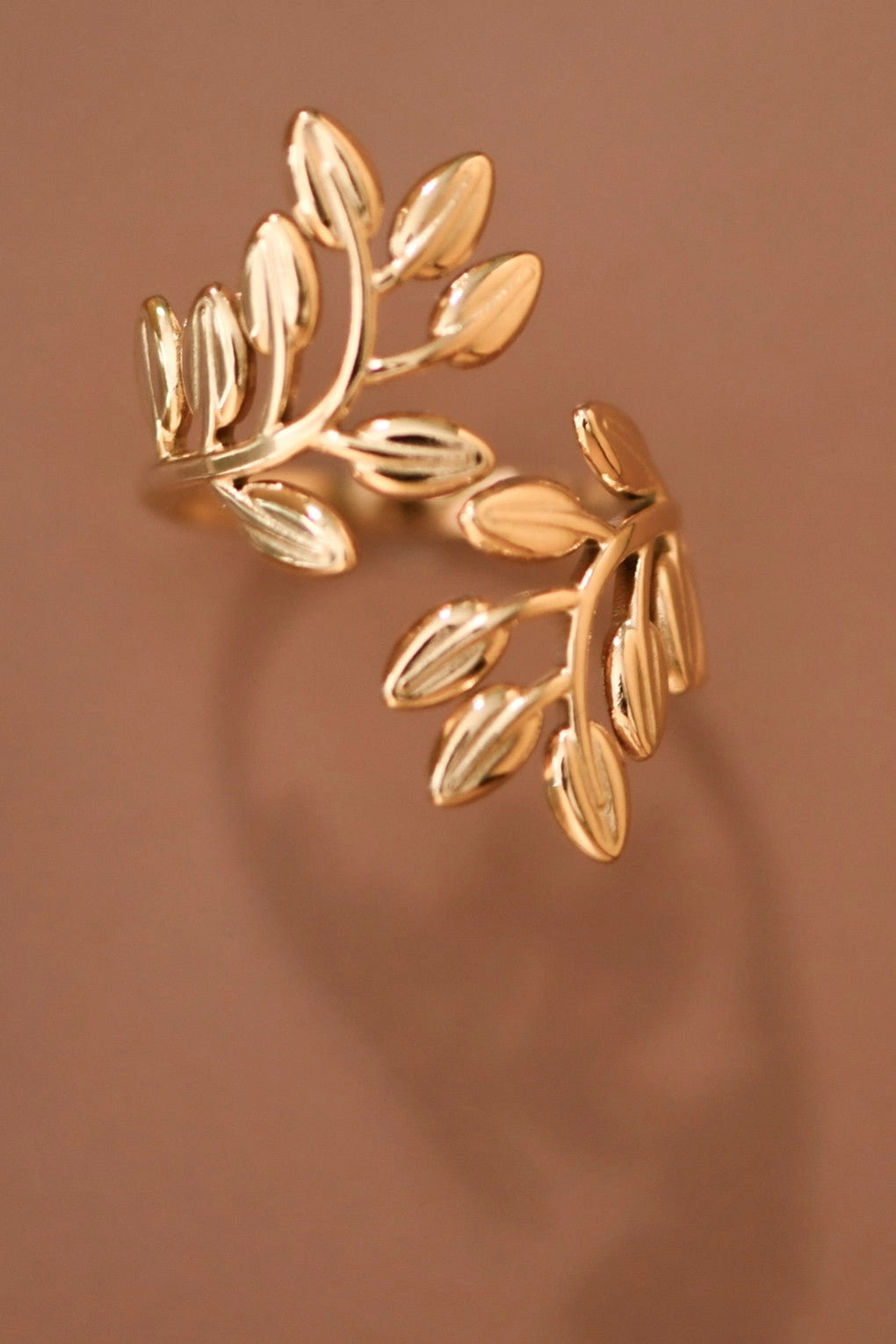Side view of the leafy branch ring highlighting the sculptural leaves and tarnish-free gold finish.