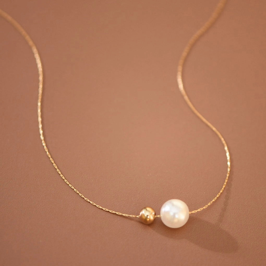 18K gold plated stainless steel necklace with half pearls and half herringbone chain by Kogi Jewelry.