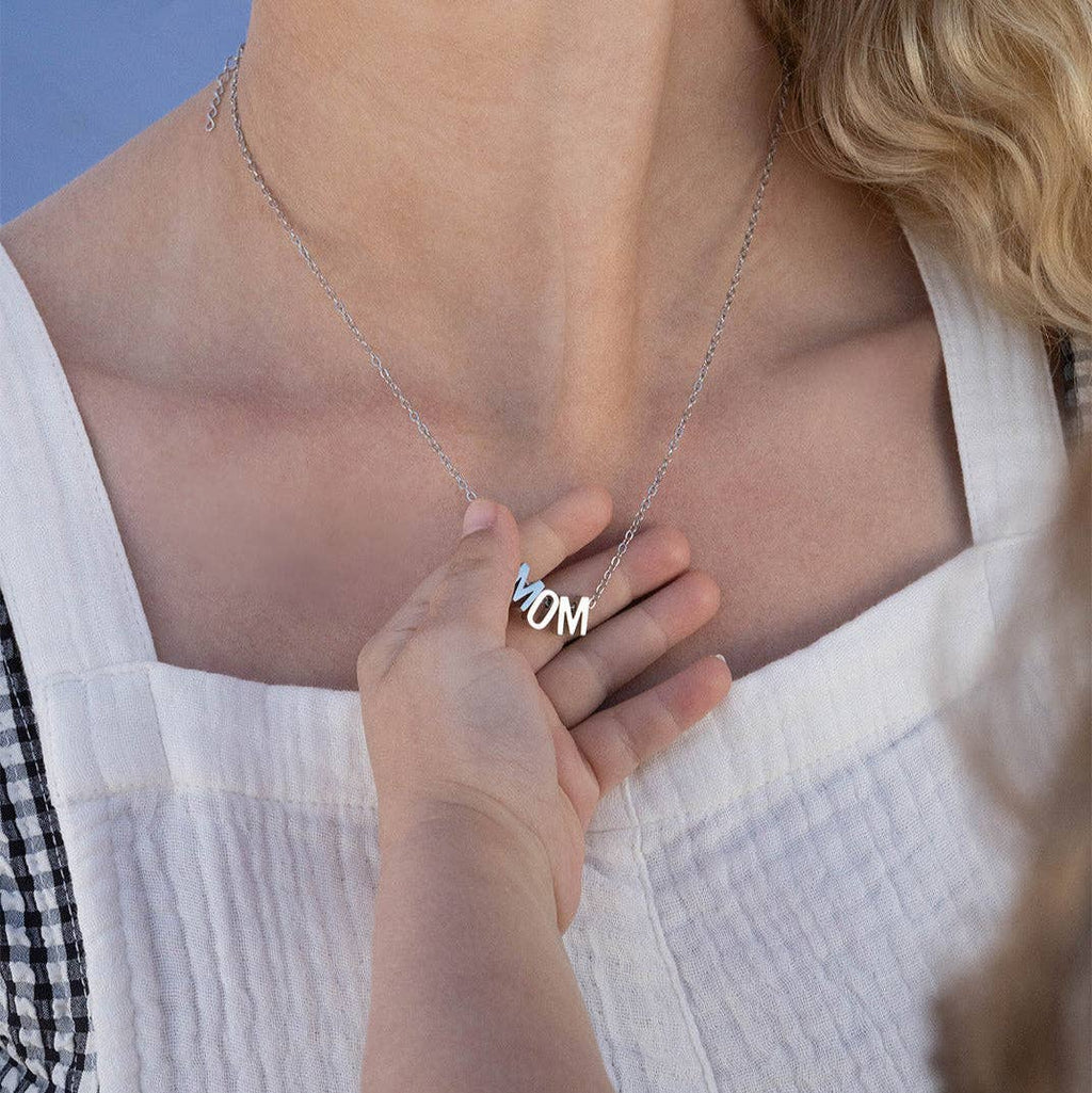 Woman wearing a delicate Silver Mom Necklace