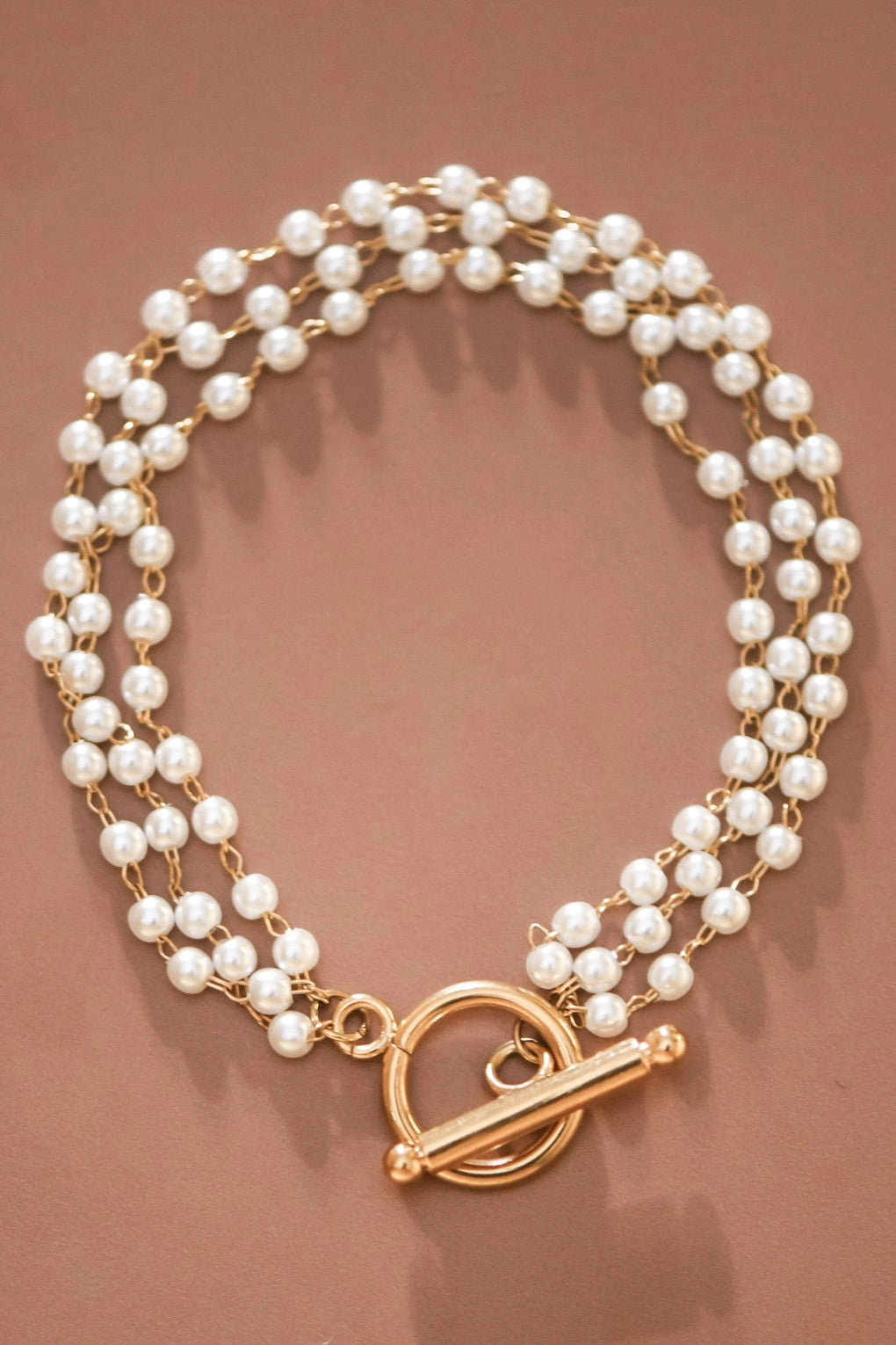 Tarnish-free 18k gold plated stainless steel bracelet with multi-strand pearls