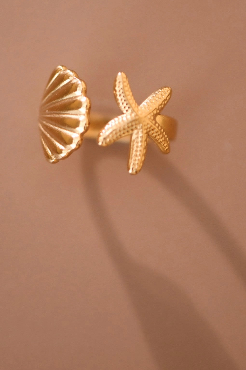 Detailed view of the starfish charm on the Kogi Jewelry gold adjustable ring.