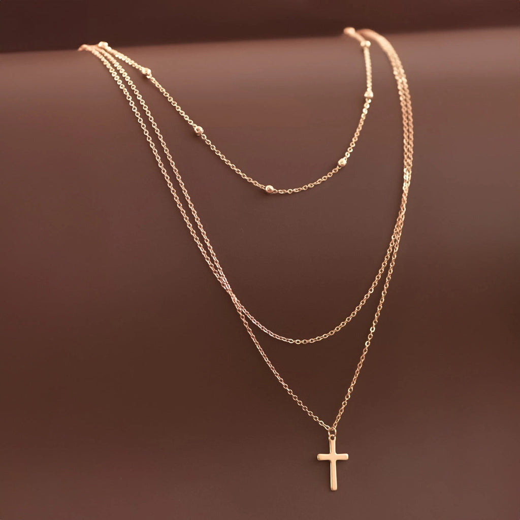 Close-up of 18k gold plated layered cross necklace showcasing the high-quality finish