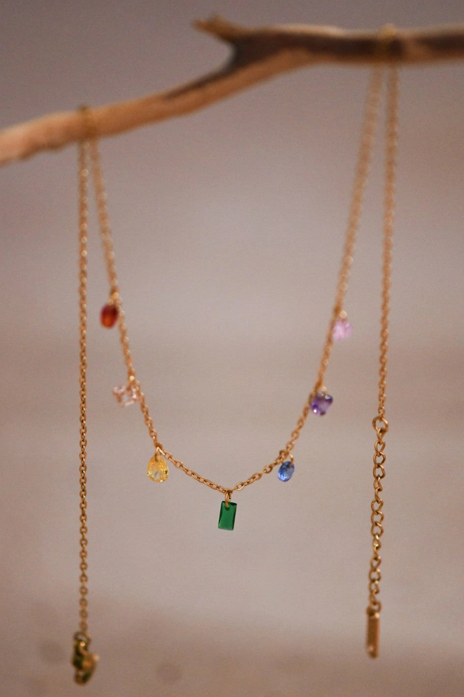 Close-up of the tarnish-free 18K gold finish and vibrant colored stones on the Kogi Jewelry chain.