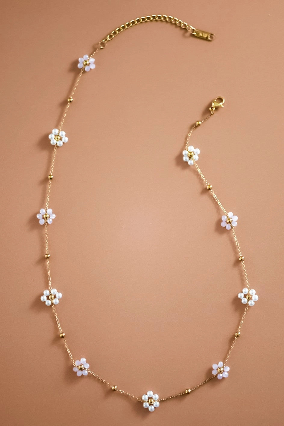 Full view of the tarnish-free 18K gold flower beaded necklace including the extension chain.
