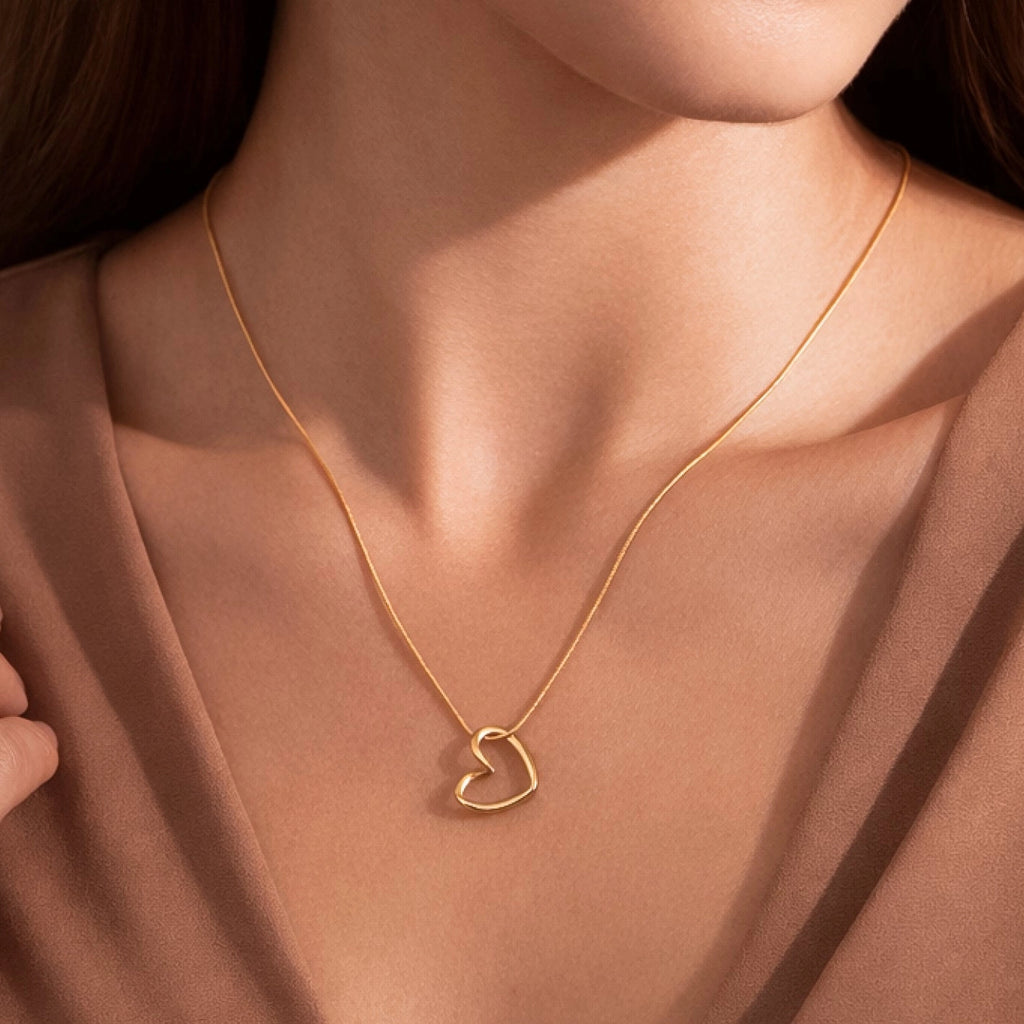 Full view of the tarnish-free 18K gold heart necklace including the lobster clasp and extension chain.